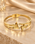 Noor gold-tone stainless steel butterfly cuff bracelet on champagne marble