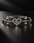 Elara anti-tarnish silver-tone heart bangle with clear stone detailing on a black background