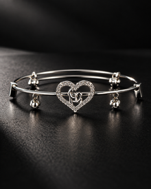 Elara anti-tarnish silver-tone heart bangle with clear stone detailing on a black background