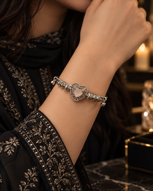 Mira Silver heart bangle worn with elegant black embroidered outfit