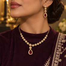 Red Celestia teardrop necklace and earrings styled with a deep-plum outfit