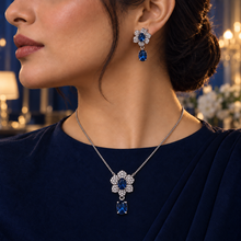 Model wearing the Liora Sapphire Blue floral necklace and matching drop earring
