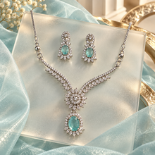 Aqua Elysia Winged Drop necklace with matching silver-tone earrings