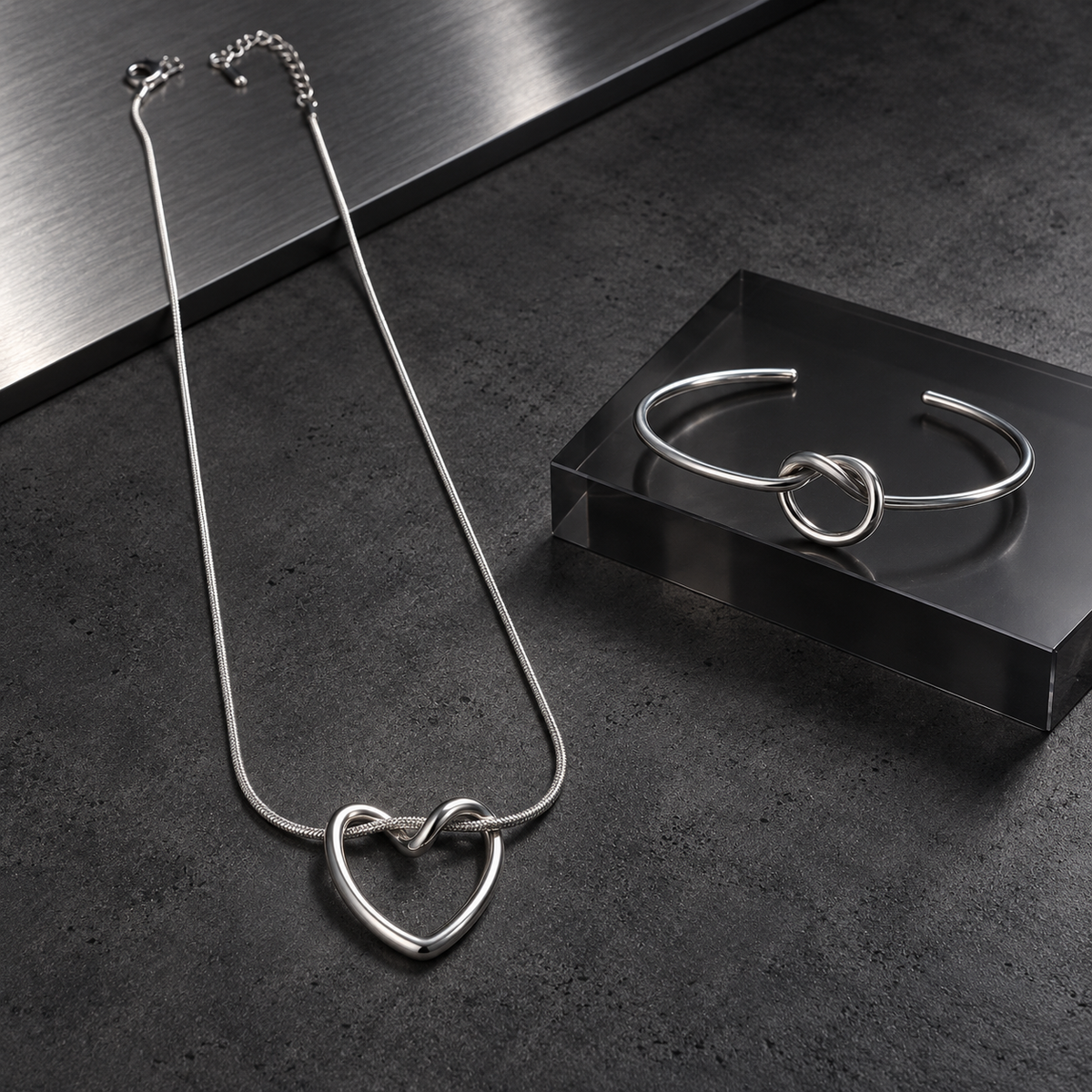 Silver Nova Loop Heart pendant necklace with matching open-cuff bracelet