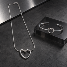 Silver Nova Loop Heart pendant necklace with matching open-cuff bracelet