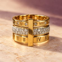 Front view of the Vela gold statement ring with a clear crystal centre band