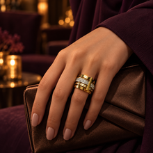 Vela gold crystal statement ring styled with a brown clutch and plum outfit