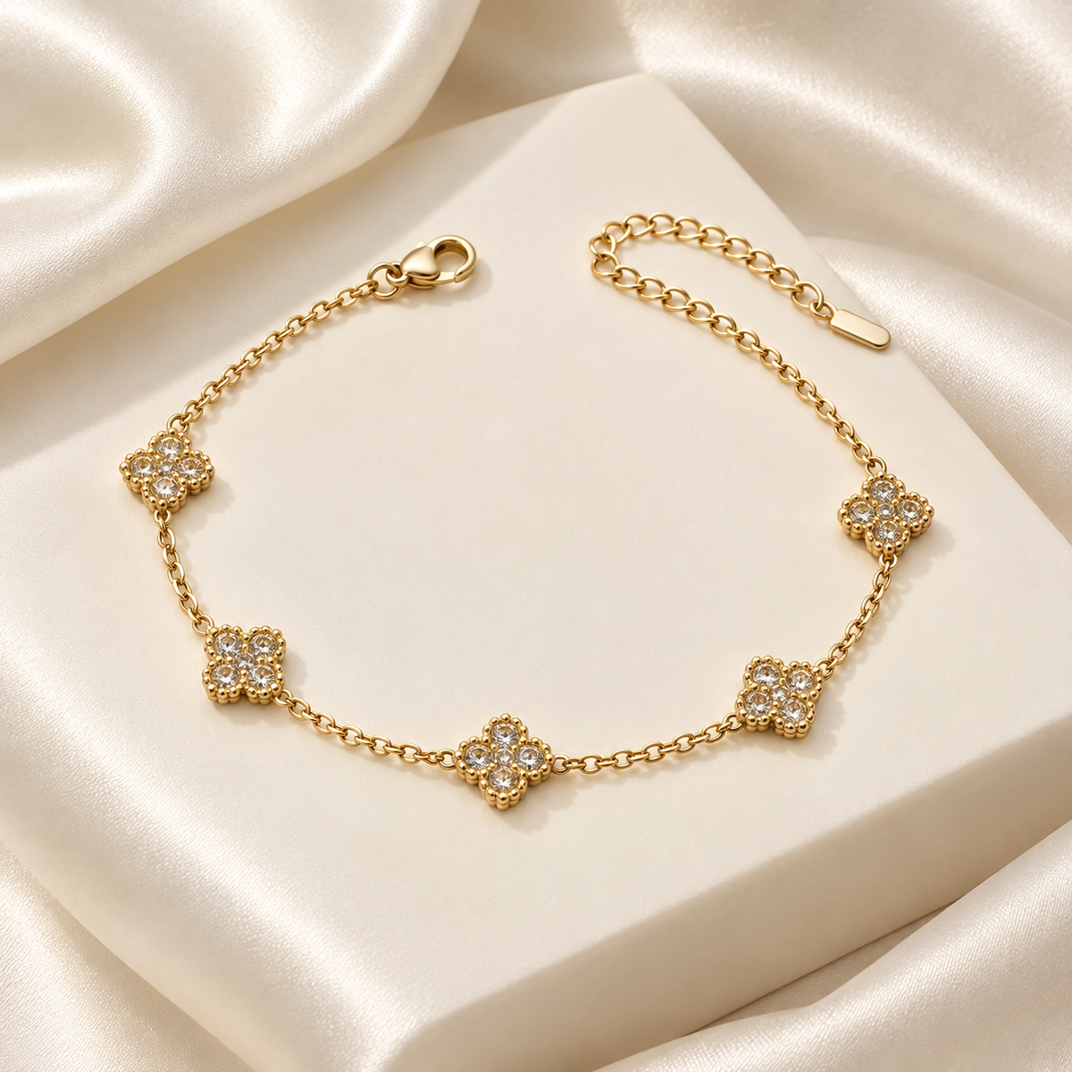 Liora Clear crystal clover bracelet displayed on ivory satin