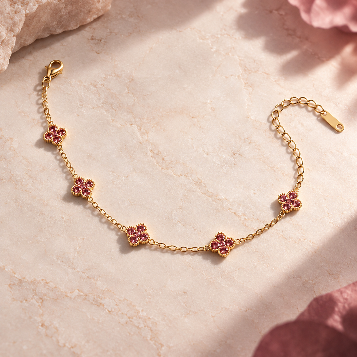 Liora Pink crystal clover bracelet displayed on an ivory surface