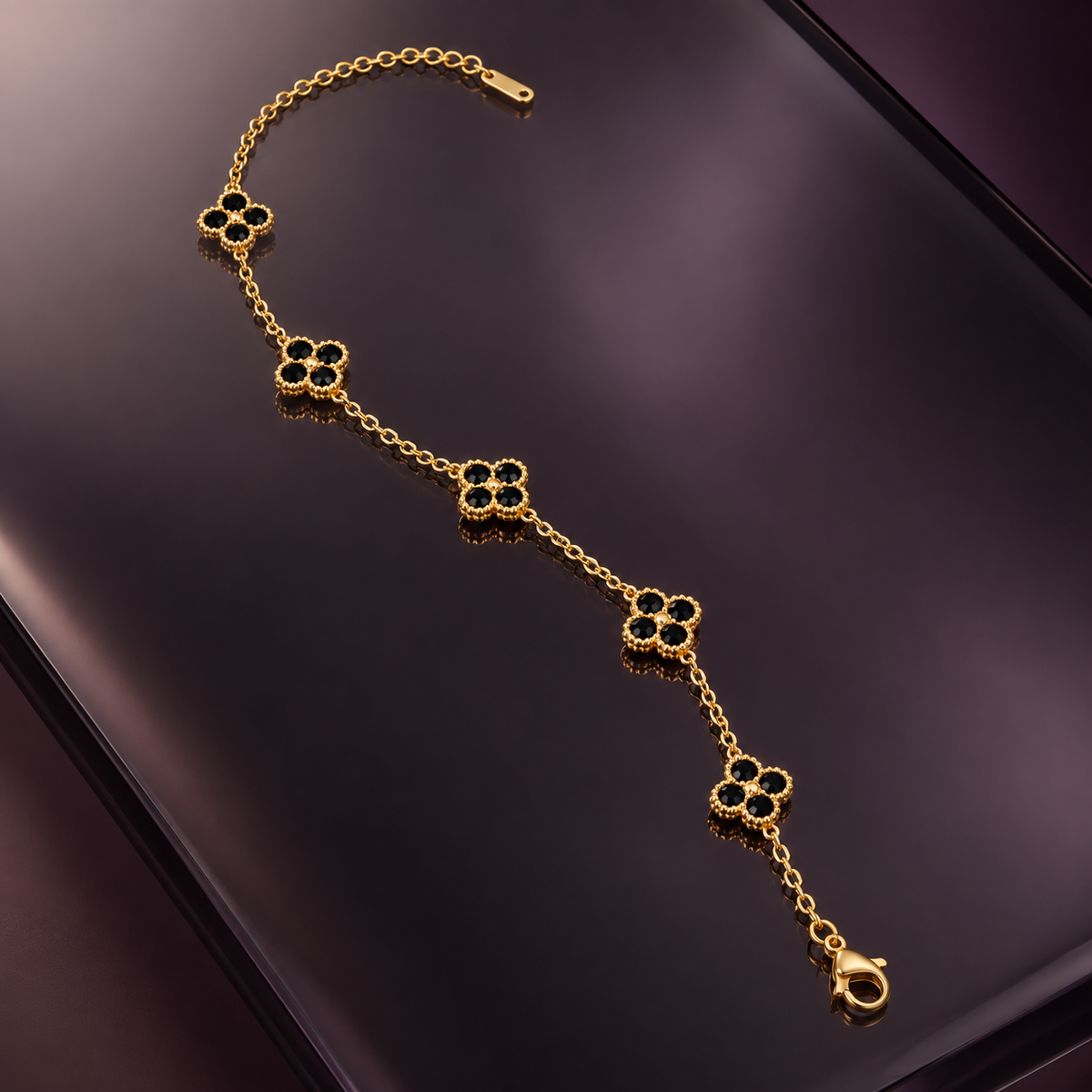 Liora Black crystal clover bracelet displayed on smoked glass