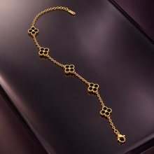 Liora Black crystal clover bracelet displayed on smoked glass