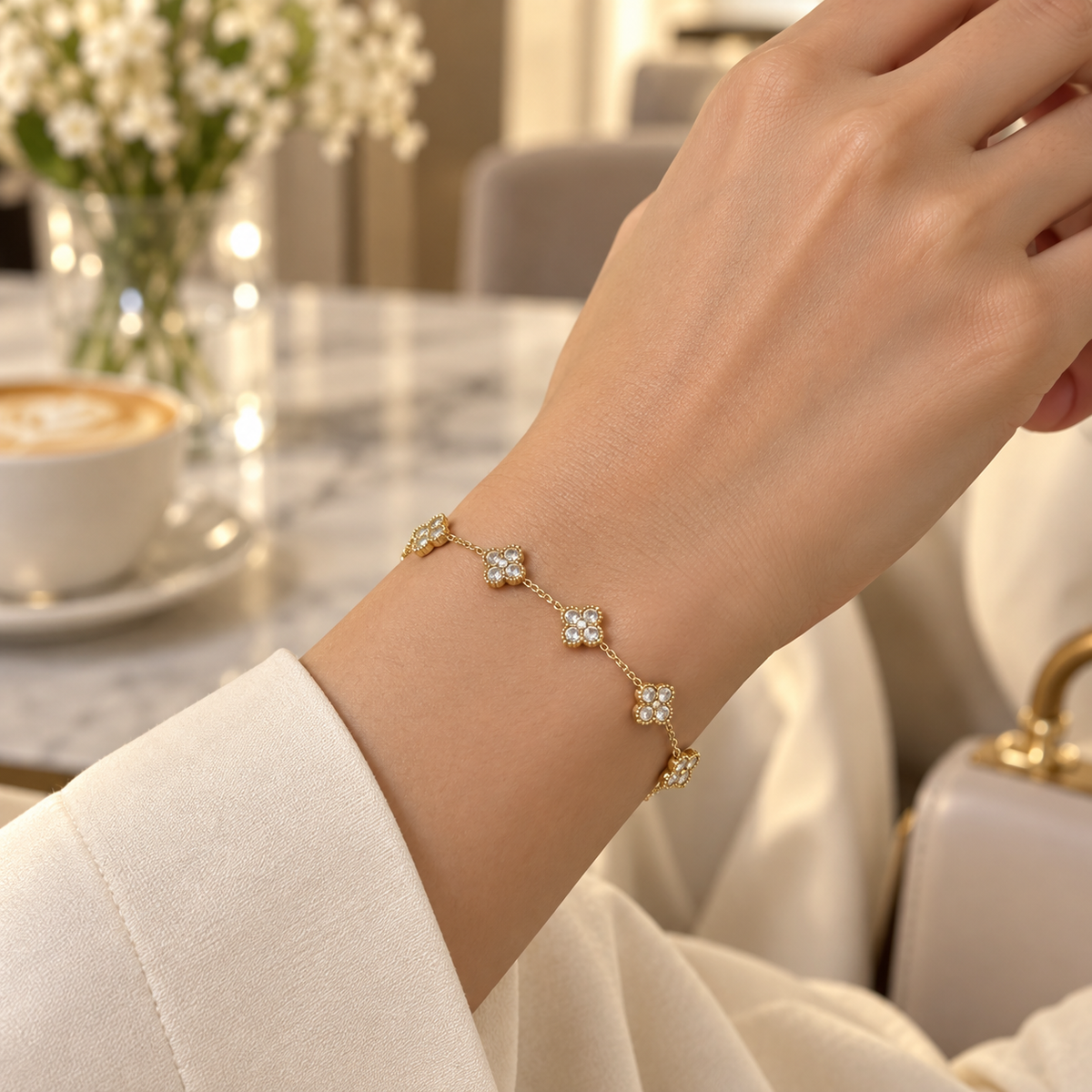 Woman wearing the Clear Liora Crystal Clover Bracelet with an ivory sleeve