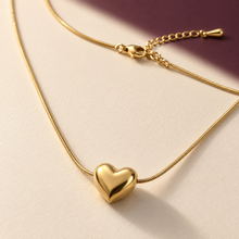Close view of the Amora smooth gold heart pendant with snake chain and extende
