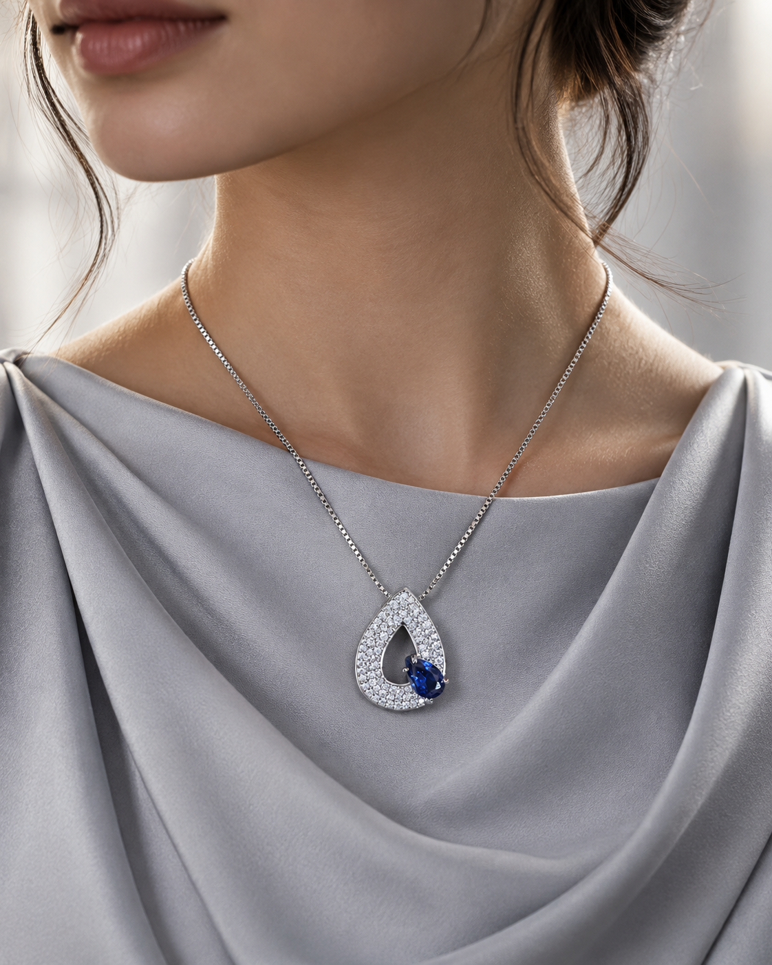 Sapphire Blue Selene S925 silver teardrop pendant necklace worn with a modest silver outfit