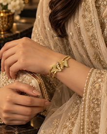 Noor butterfly cuff bracelet styled with cream embroidered formalwear and clutch
