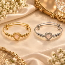 Mira heart charm bangle in Gold and Silver displayed separately side by side