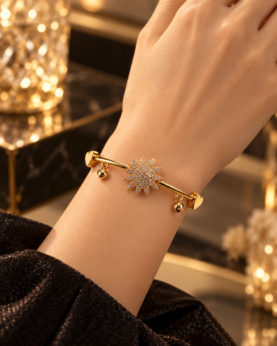 Gold starburst bangle bracelet worn on the wrist with elegant luxury styling